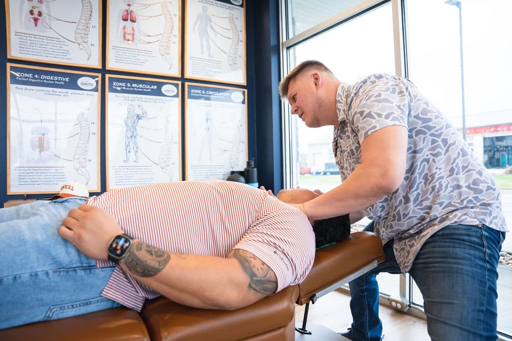 Ignite Chiropractic — patient adjustment with zone technique charts